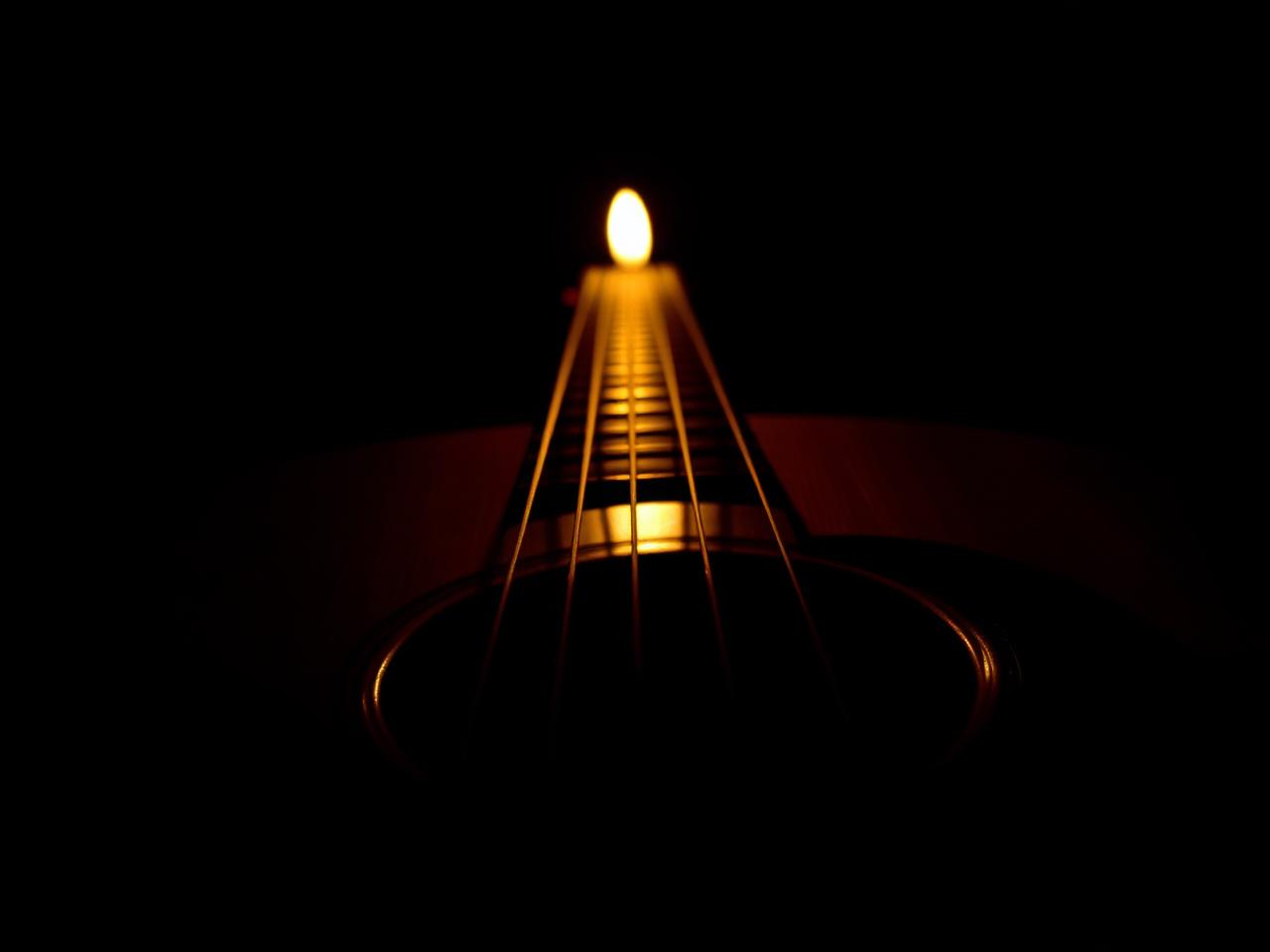 Acoustic guitar in warm candlelight